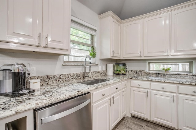 1017 Thistle Hill Trl, Weatherford, TX 76087 - kitchen with dishwasher, a sink, white cabinetry, light stone counters, and light wood-style flooring