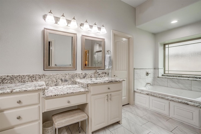 1017 Thistle Hill Trl, Weatherford, TX 76087 - full bathroom with a garden tub, vanity, and marble look tiles