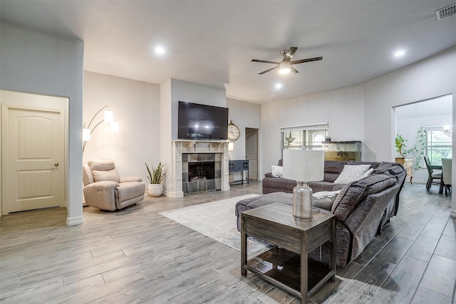 1017 Thistle Hill Trl, Weatherford, TX 76087 - living area featuring ceiling fan, wood finished floors, plenty of natural light, a tile fireplace, and recessed lighting