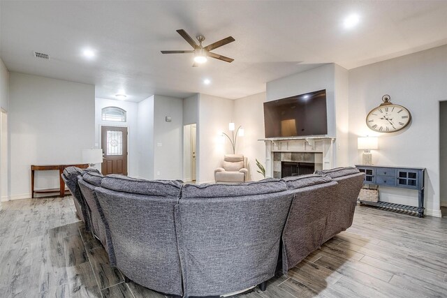 1017 Thistle Hill Trl, Weatherford, TX 76087 - living room with a ceiling fan, wood finished floors, a tiled fireplace, baseboards, and recessed lighting