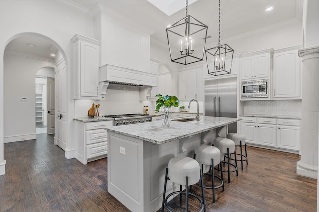 6644 Josephine St, Plano, TX 75024 - kitchen with built in appliances, a sink, recessed lighting, ornamental molding, and white cabinets