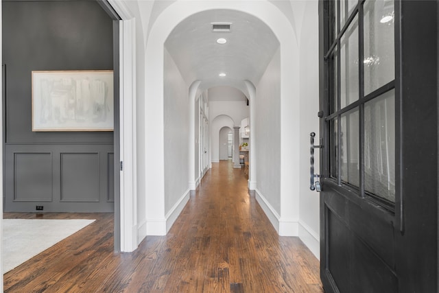 6644 Josephine St, Plano, TX 75024 - foyer featuring arched walkways, dark wood-type flooring, and baseboards