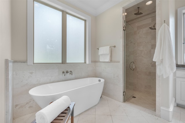 6644 Josephine St, Plano, TX 75024 - bathroom with a stall shower, a freestanding tub, tile walls, and ornamental molding
