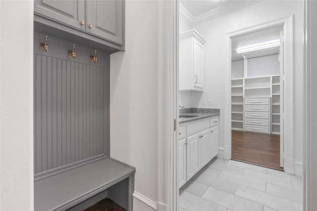 6644 Josephine St, Plano, TX 75024 - mudroom featuring crown molding, light tile patterned floors, and a sink
