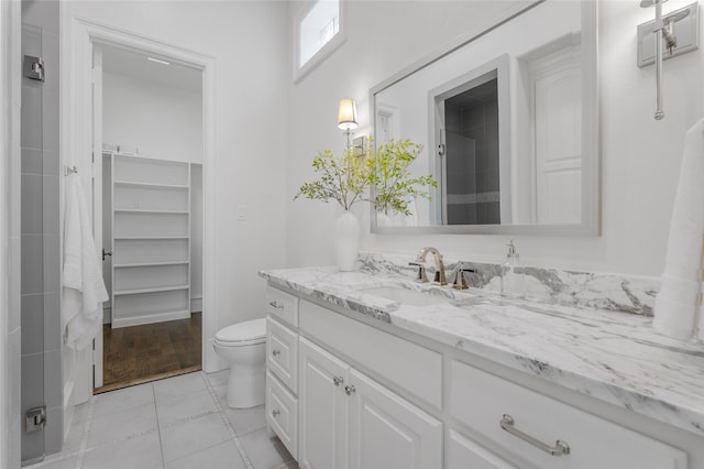 6644 Josephine St, Plano, TX 75024 - full bathroom with vanity, toilet, tile patterned floors, a closet, and a shower