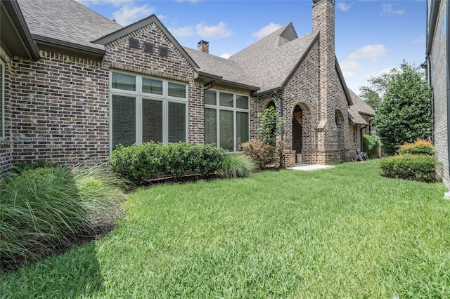 6644 Josephine St, Plano, TX 75024 - back of property featuring a chimney, a lawn, brick siding, and roof with shingles