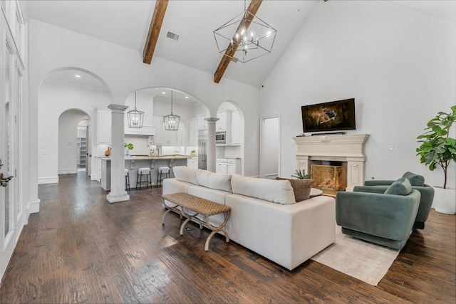 6644 Josephine St, Plano, TX 75024 - living area featuring high vaulted ceiling, a chandelier, arched walkways, a lit fireplace, and dark wood-type flooring