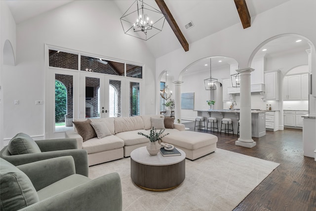 6644 Josephine St, Plano, TX 75024 - living area featuring high vaulted ceiling, a chandelier, arched walkways, wood finished floors, and beam ceiling