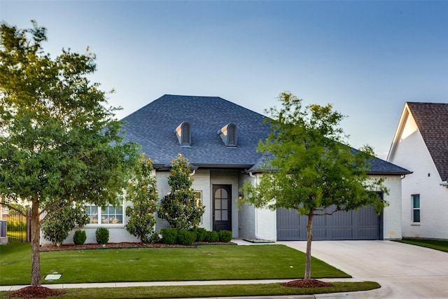 712 Tallgrass Dr, Aledo, TX 76008 - french country inspired facade with roof with shingles, driveway, an attached garage, brick siding, and a front yard