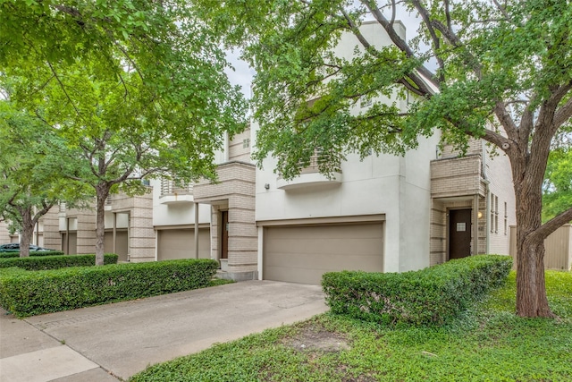 4302 Gilbert Ave, Dallas, TX 75219 - view of front of house with a garage, driveway, brick siding, and stucco siding