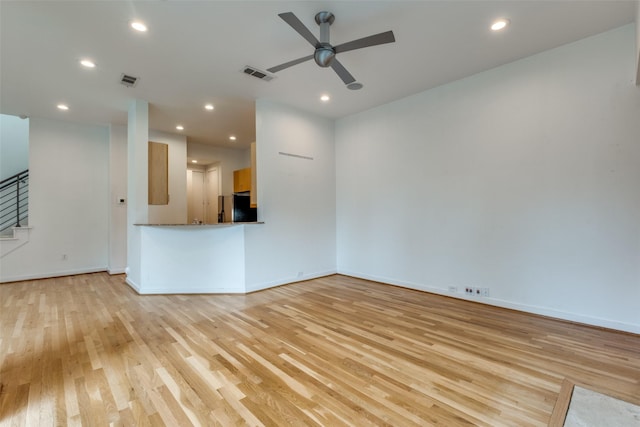 4302 Gilbert Ave, Dallas, TX 75219 - unfurnished living room with light wood finished floors, ceiling fan, stairway, recessed lighting, and baseboards