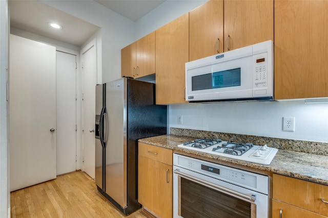 4302 Gilbert Ave, Dallas, TX 75219 - kitchen with appliances with stainless steel finishes, light wood-style flooring, light stone countertops, and recessed lighting