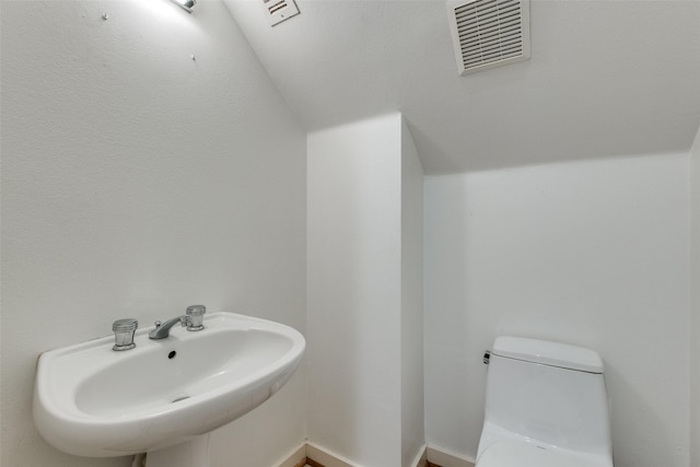 4302 Gilbert Ave, Dallas, TX 75219 - half bathroom featuring a sink and toilet