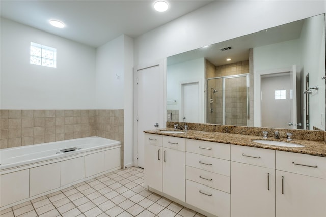 4302 Gilbert Ave, Dallas, TX 75219 - bathroom featuring double vanity, a shower stall, a garden tub, and tile patterned floors