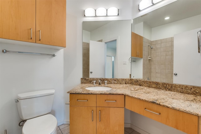 4302 Gilbert Ave, Dallas, TX 75219 - full bathroom with toilet, vanity, tile patterned floors, baseboards, and a shower