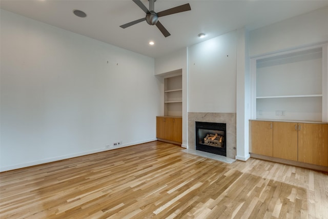 4302 Gilbert Ave, Dallas, TX 75219 - unfurnished living room featuring a ceiling fan, light wood-style floors, a fireplace, built in features, and recessed lighting