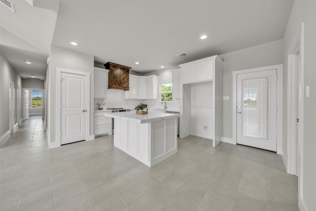 498 Cumberland Trl, Bridgeport, TX 76458 - kitchen featuring white cabinets, a sink, light countertops, a center island, and recessed lighting