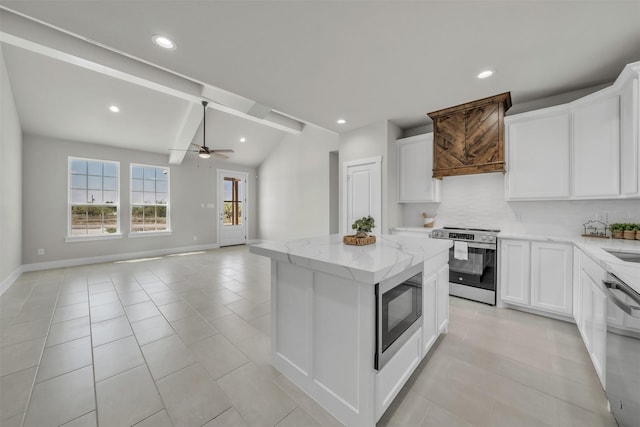 498 Cumberland Trl, Bridgeport, TX 76458 - kitchen with appliances with stainless steel finishes, ceiling fan, a kitchen island, vaulted ceiling, and tasteful backsplash