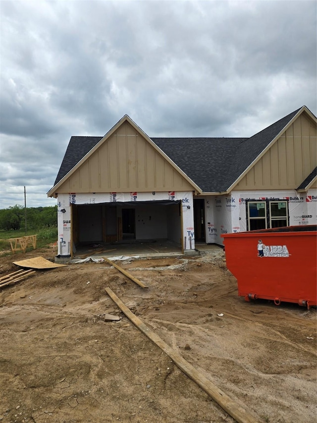 498 Cumberland Trl, Bridgeport, TX 76458 - view of front of home with a shingled roof, board and batten siding, and a garage