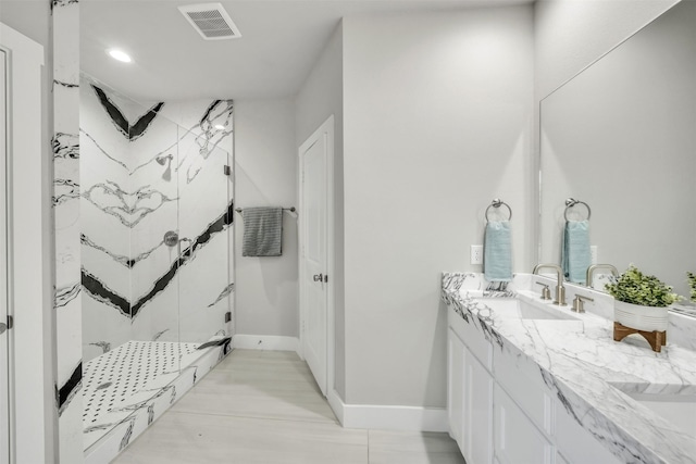 498 Cumberland Trl, Bridgeport, TX 76458 - bathroom featuring a marble finish shower, double vanity, baseboards, and recessed lighting