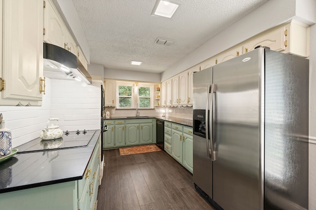 7529 Mapleleaf Dr, North Richland Hills, TX 76182 - kitchen with black appliances, green cabinets, under cabinet range hood, a textured ceiling, and dark wood-style floors