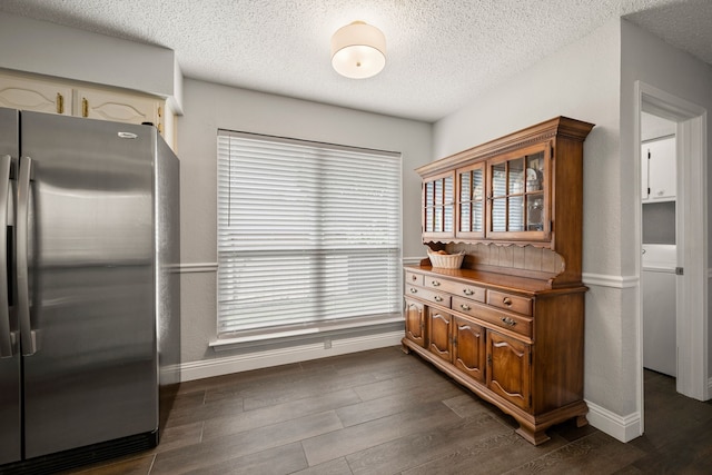 7529 Mapleleaf Dr, North Richland Hills, TX 76182 - kitchen featuring freestanding refrigerator, a textured ceiling, dark wood finished floors, and baseboards
