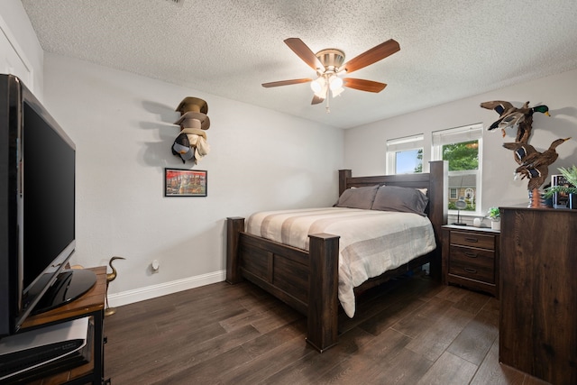 7529 Mapleleaf Dr, North Richland Hills, TX 76182 - bedroom featuring dark wood-style flooring, a textured ceiling, baseboards, and a ceiling fan