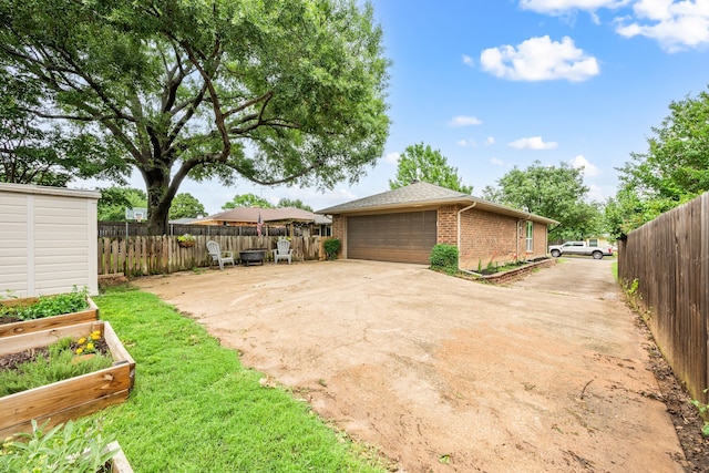 7529 Mapleleaf Dr, North Richland Hills, TX 76182 - view of yard with a garden and a detached garage