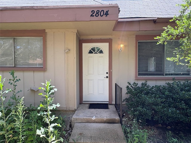 2804 W Walnut Hill Ln, Irving, TX 75038 - entrance to property with board and batten siding and a shingled roof