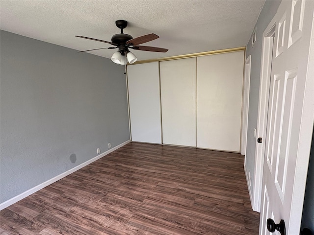 2804 W Walnut Hill Ln, Irving, TX 75038 - unfurnished bedroom featuring wood finished floors, a textured ceiling, a closet, ceiling fan, and baseboards