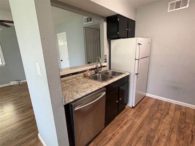 2804 W Walnut Hill Ln, Irving, TX 75038 - kitchen featuring dishwasher, dark wood-style floors, a sink, and freestanding refrigerator
