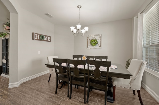 1120 Pinnacle Ridge Rd, Fort Worth, TX 76052 - dining space featuring wood finished floors, a chandelier, arched walkways, and baseboards
