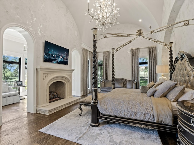 4905 Reserve Ct, Parker, TX 75002 - bedroom with a chandelier, multiple windows, arched walkways, wood finished floors, and lofted ceiling