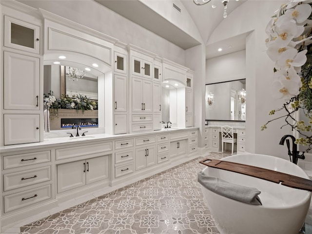 4905 Reserve Ct, Parker, TX 75002 - full bath with double vanity, lofted ceiling, a chandelier, recessed lighting, and a soaking tub