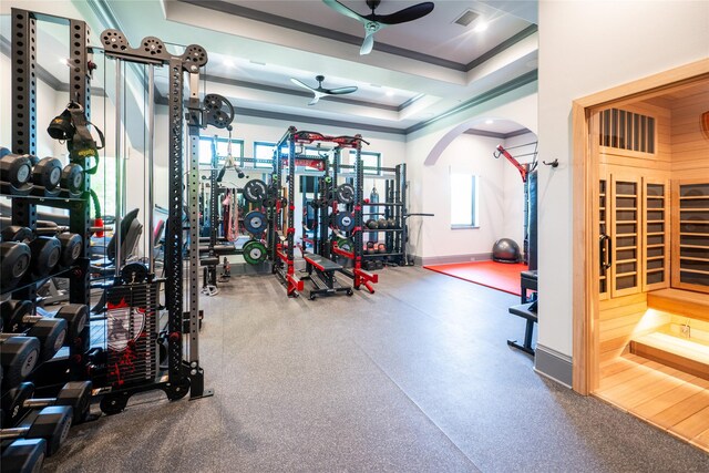 4905 Reserve Ct, Parker, TX 75002 - workout area featuring crown molding, a ceiling fan, baseboards, a raised ceiling, and arched walkways