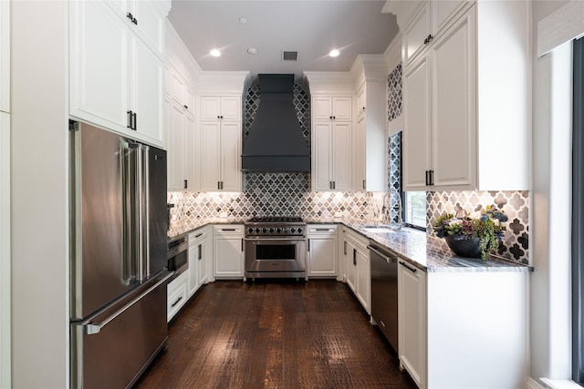 4905 Reserve Ct, Parker, TX 75002 - kitchen featuring premium appliances, premium range hood, a sink, light stone countertops, and white cabinetry