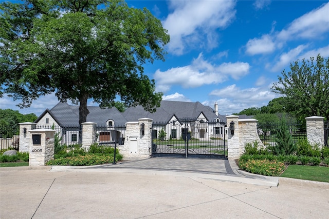 4905 Reserve Ct, Parker, TX 75002 - french country style house with stone siding, a fenced front yard, and a gate