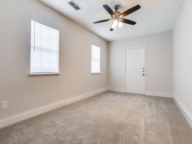 1810 Running River Rd, Garland, TX 75044 - spare room featuring a ceiling fan, light colored carpet, and baseboards