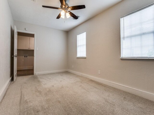 1810 Running River Rd, Garland, TX 75044 - unfurnished bedroom featuring light colored carpet and a ceiling fan