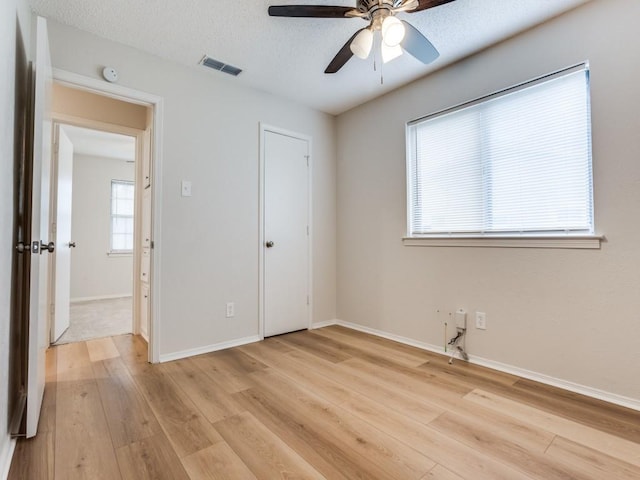 1810 Running River Rd, Garland, TX 75044 - unfurnished bedroom with light wood-style flooring, baseboards, and a ceiling fan