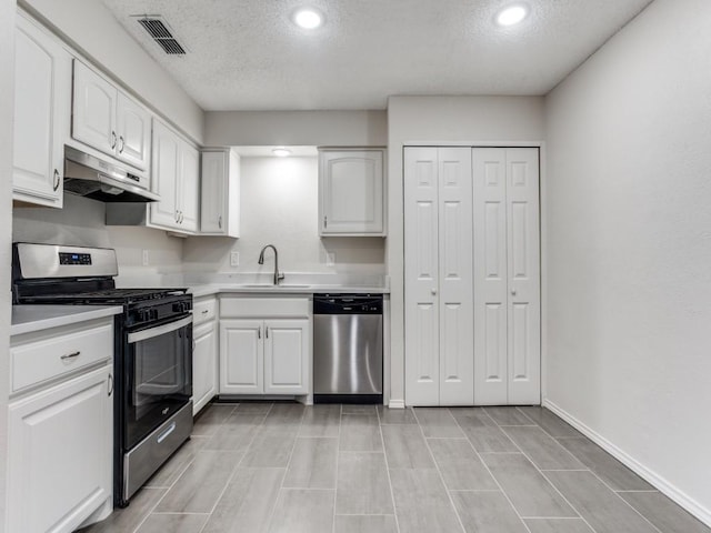 1810 Running River Rd, Garland, TX 75044 - kitchen with appliances with stainless steel finishes, under cabinet range hood, a textured ceiling, white cabinets, and light countertops