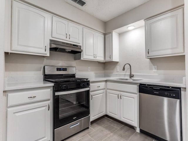1810 Running River Rd, Garland, TX 75044 - kitchen featuring appliances with stainless steel finishes, under cabinet range hood, white cabinets, light countertops, and a textured ceiling