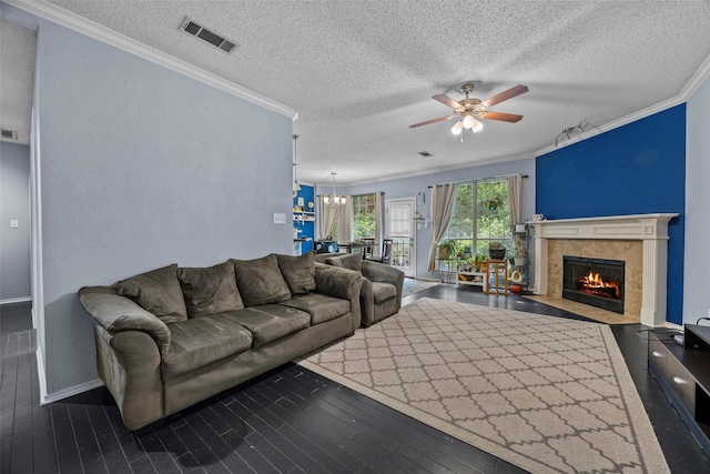 7421 Buckskin Ct, Fort Worth, TX 76137 - living area featuring ornamental molding, ceiling fan, a textured ceiling, a chandelier, and a tiled fireplace