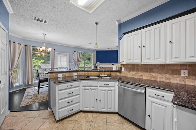 7421 Buckskin Ct, Fort Worth, TX 76137 - kitchen with stainless steel dishwasher, a sink, a peninsula, white cabinets, and a chandelier