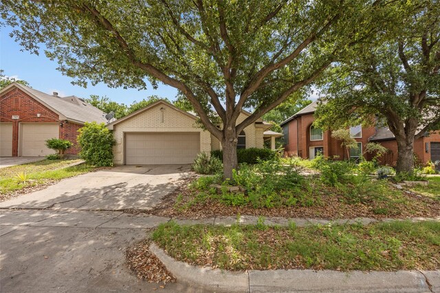 7421 Buckskin Ct, Fort Worth, TX 76137 - view of front of home with brick siding, a garage, and concrete driveway