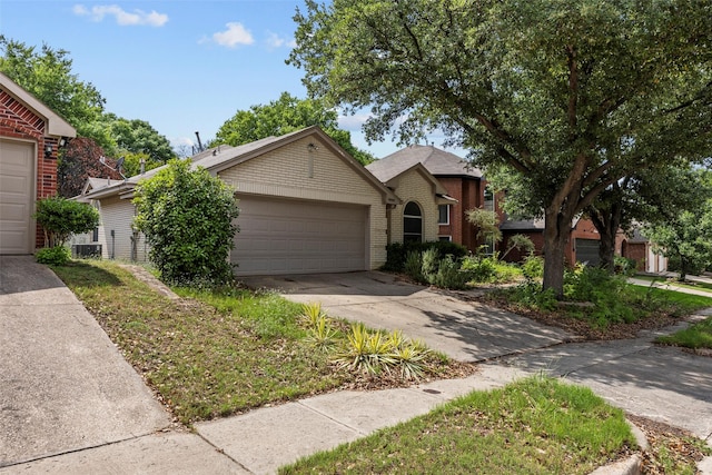 7421 Buckskin Ct, Fort Worth, TX 76137 - view of front of home featuring driveway, a garage, brick siding, and central AC