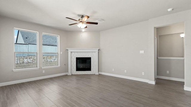 11213 Orchard Ln, Justin, TX 76247 - unfurnished living room with a ceiling fan, baseboards, a fireplace, and wood finished floors
