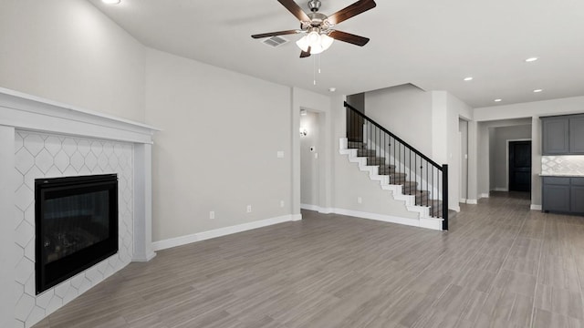 11213 Orchard Ln, Justin, TX 76247 - unfurnished living room with ceiling fan, stairs, a fireplace, recessed lighting, and baseboards