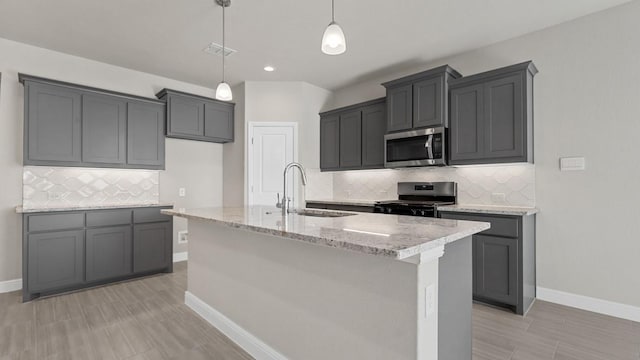 11213 Orchard Ln, Justin, TX 76247 - kitchen with appliances with stainless steel finishes, a sink, light stone counters, tasteful backsplash, and baseboards