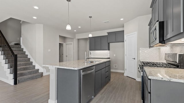 11213 Orchard Ln, Justin, TX 76247 - kitchen with a sink, stainless steel appliances, light stone counters, tasteful backsplash, and recessed lighting